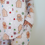Close-up of pajama pants with gingerbread man and house pattern on a light background