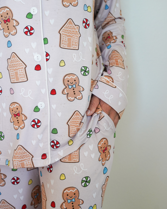 Close-up of pajama pants with gingerbread man and house pattern on a light background