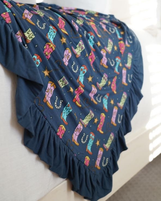 Girly Boots print on a ruffle blanket laying on a bed