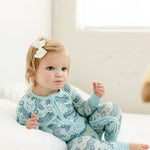 girl wearing bamboo toddler pajamas with blue tiger print